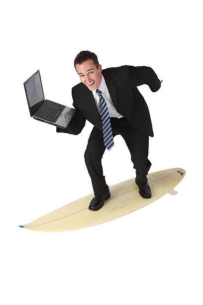 istock Businessman surfing on surfboard and carrying a laptop 183290318