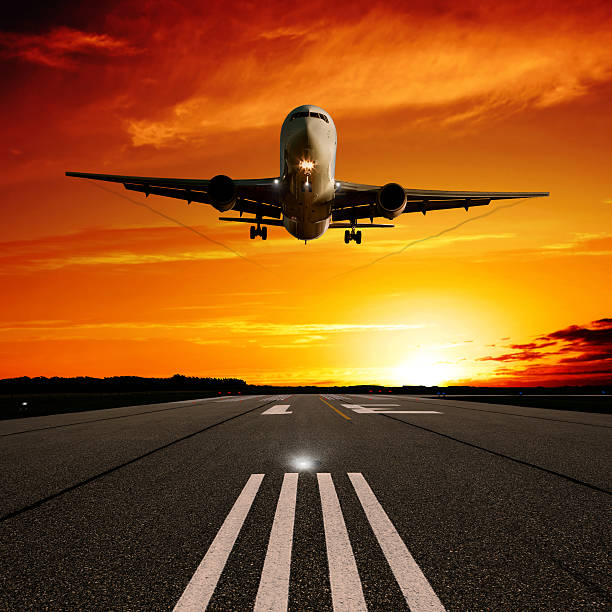 istock XL jet airplane landing at sunset 183290492