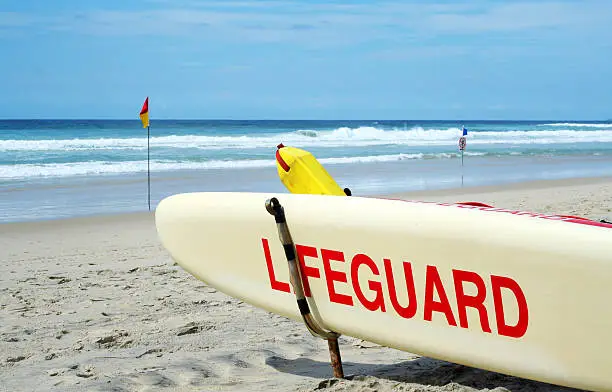 A surf ski on standby at the beach.
