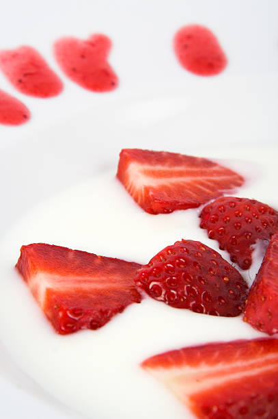Strawberry's in yoghurt Delicious strawberry's in a dish of yoghurt cerial stock pictures, royalty-free photos & images