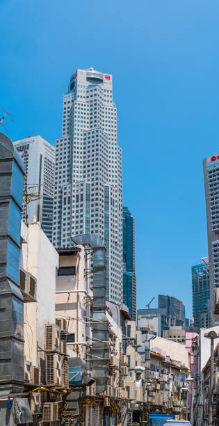 Modern skyscrapers towering over crowded street below vertical panorama Singapore