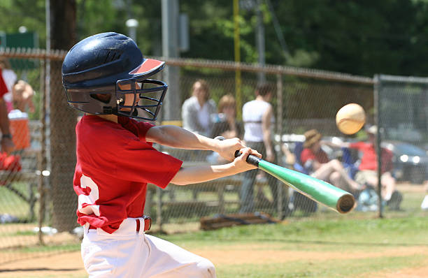 Youth League Batter a boy hitting a baseball youth baseball and softball league photos stock pictures, royalty-free photos & images