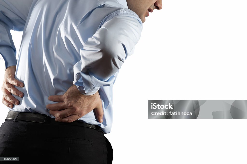 Back Pain Young man is holding his back. Adult Stock Photo