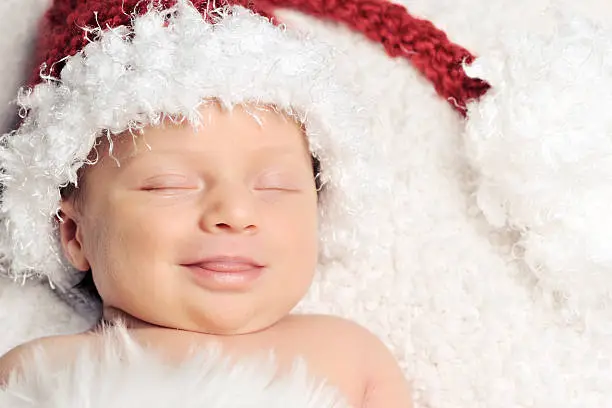 babyborn with a christmas hat who is smiling while dreaming.Please see this similar picture from my portfolio :
