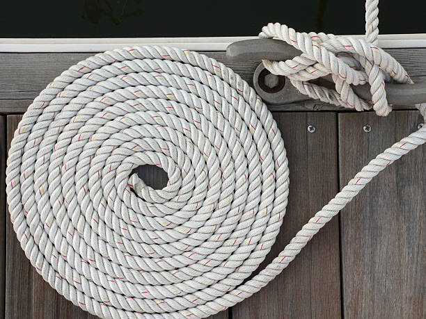 mooring rope Neatly fastened and coiled mooring rope from a boat.Additional rope images: mooring line stock pictures, royalty-free photos & images