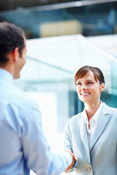 istock Beautiful business woman shaking hands with man 183292047