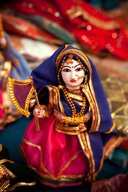 Indian Folk Dolls Indian puppet dolls in the outdoor market in Agra.These sites are common all over India, where tourists stop by to purchase mementos. These figurines are home made crafts, not copyright pieces of art work. doll puppet indian culture small stock pictures, royalty-free photos & images