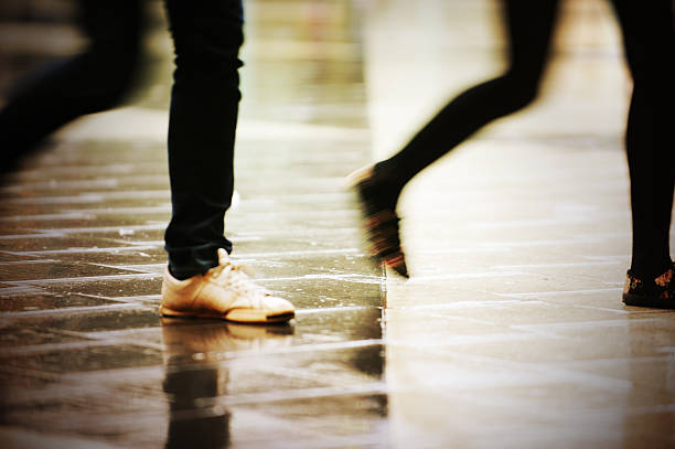 istock Pedestrians on rain wet square 183292518