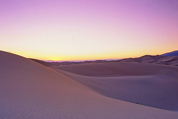 sand dune sunset landscape "nature scenery and natural landmarks: abstract purple and yellow sand dune twilight landscape, great sand dunes national park, colorado, usa" great sand dunes national park stock pictures, royalty-free photos & images