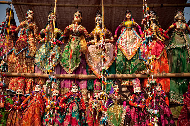Indian Folk Dolls "Indian puppet dolls in the outdoor market in Agra.These sites are common all over India, where tourists stop by to purchase mementos. These figurines are home made crafts, not copyright pieces of art work." doll puppet indian culture small stock pictures, royalty-free photos & images