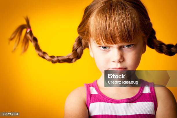 Grumpy Redhaired Girl With Upward Braids And A Scowl Stock Photo - Download Image Now