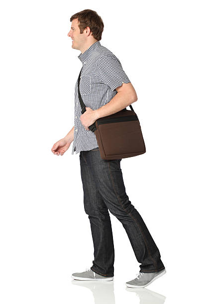 istock Isolated casual man walking with shoulder bag 183293533
