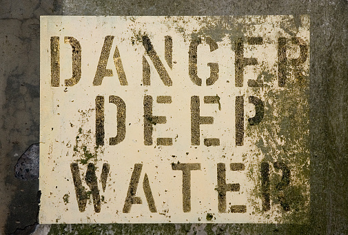 Stencilled sign on aged concrete in Scotland, UK.