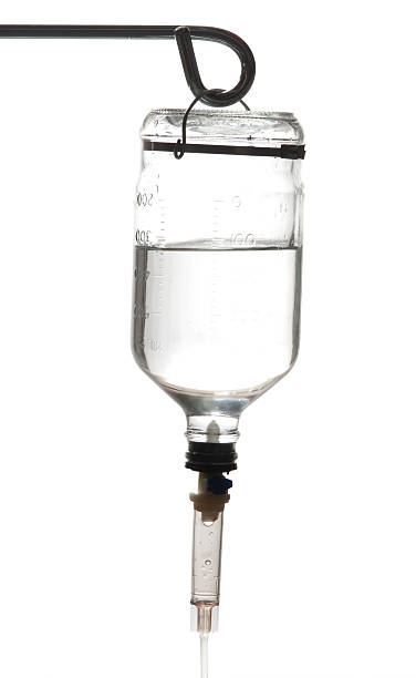 Old IV Bottle "Closeup of an old, glass IV bottle against a white background.Other images in this series:" infused oil stock pictures, royalty-free photos & images