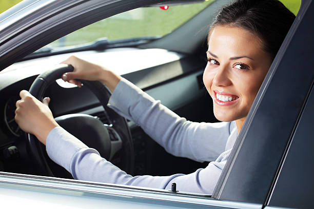 istock Business woman looking at camera through the car window. 183294161
