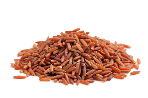 Camargue Red Rice in a heap isolated on a white background.