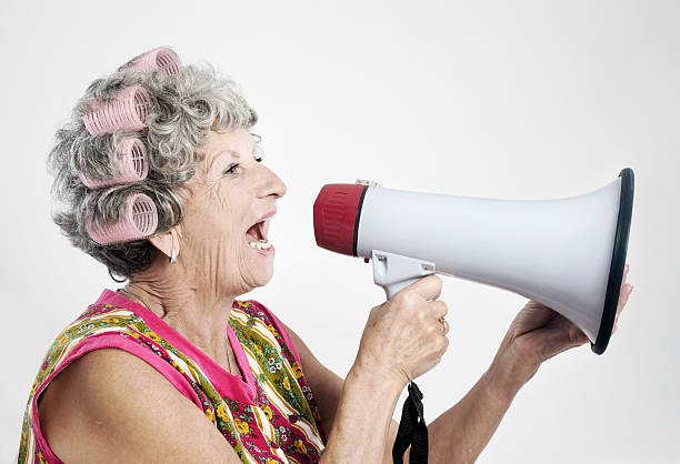istock Senior woman shouting in megaphon 183294503