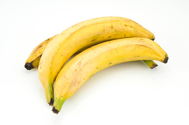 Plantain Yellow Plantains on White Background. Note that they were not retouched to retain it's original appearance. plantain stock pictures, royalty-free photos & images