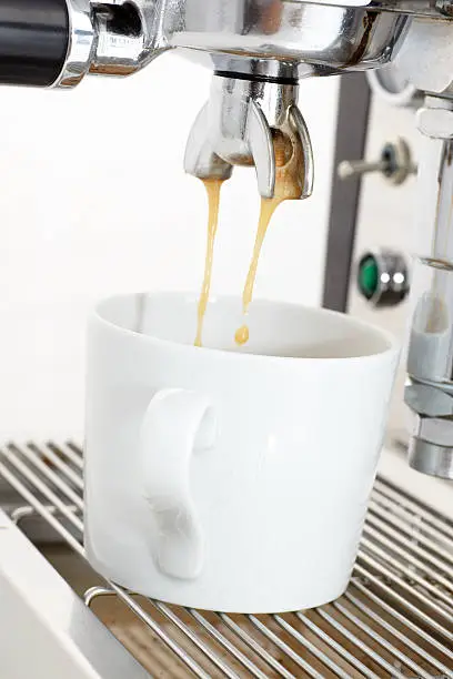 Close-up of an espresso machine at work.