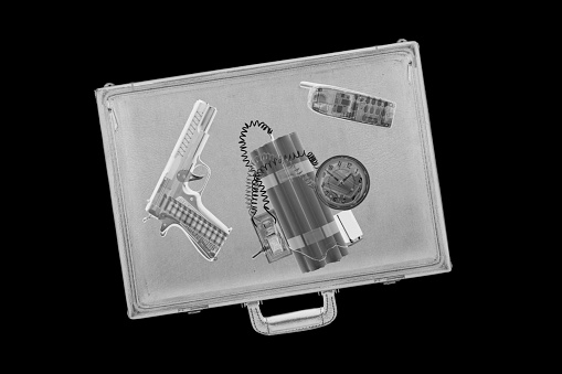 XXL. Airport x-ray image of a briefcase with a handgun and bomb inside.