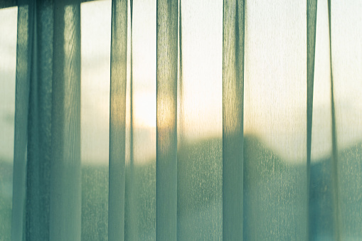 The evening sunlight reflects on the curtains for background.