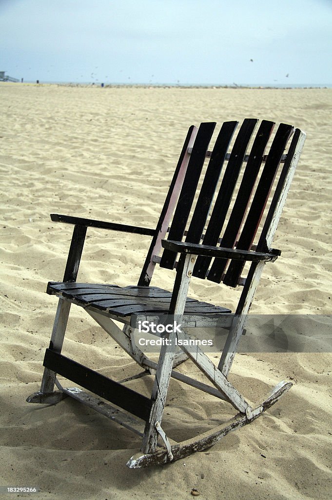 beachchair weathered wooden rocking chair at the beach Antique Stock Photo