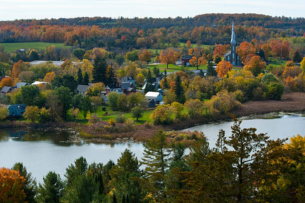 Beautiful Credit River With Colorful Fall Foliage in the Background and Seagulls Resting on the Rocky Shallow Parts of the River Bed