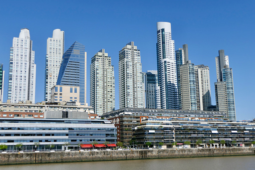 The architectural style of the commercial district of Buenos Aires, Puerto Madero, is modern skyscrapers, in stark contrast to the art deco focus of downtown. Puerto Madero sits along the Rio de Plata.