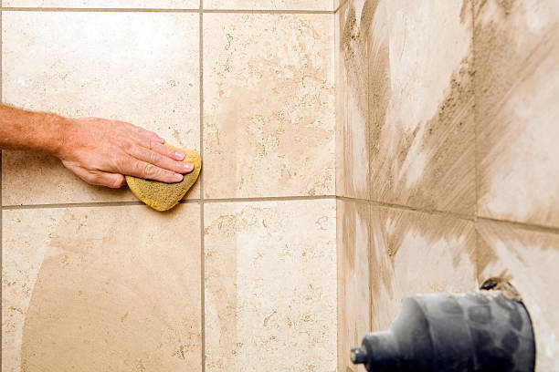 istock Tile Setter Wiping Grout from Shower Wall 183296030