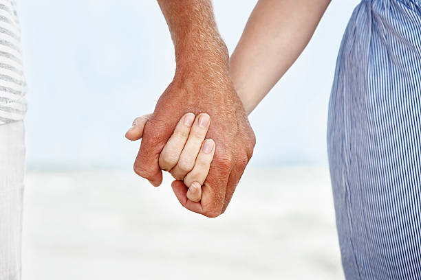 Romantic scene - Young couple holding hands