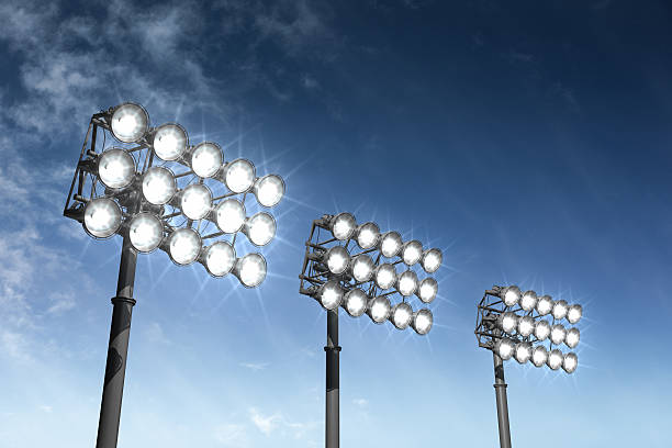 Large stadium lights isolated on a sky background.Could be a useful element in a sports composition.This is a detailed 3d rendering.