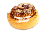 A tasty cinnamon bun with icing on a white background