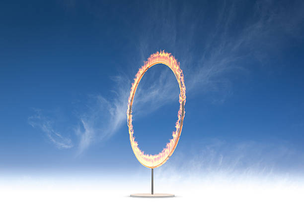 istock A vertical ring of fire on a stand in front of a blue sky 183296784