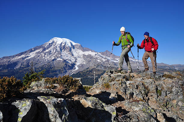Two men hiking the Mountain Rainier stock photo