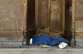 Homeless sleeping on ground.