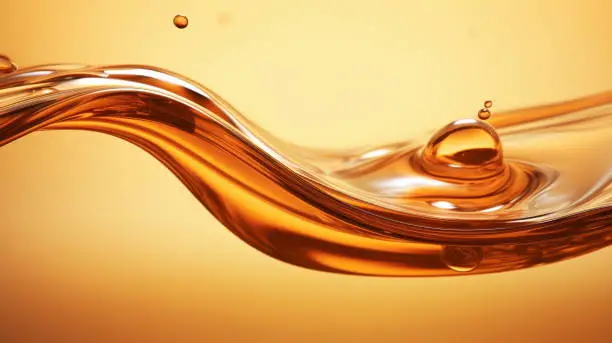 Photo of Splashes and drops of liquid oil. Fresh Olive or motor engine oil eco nature golden color close-up. Shine yellow Cosmetic oil or Cosmetic Essence Liquid drop. 3d render