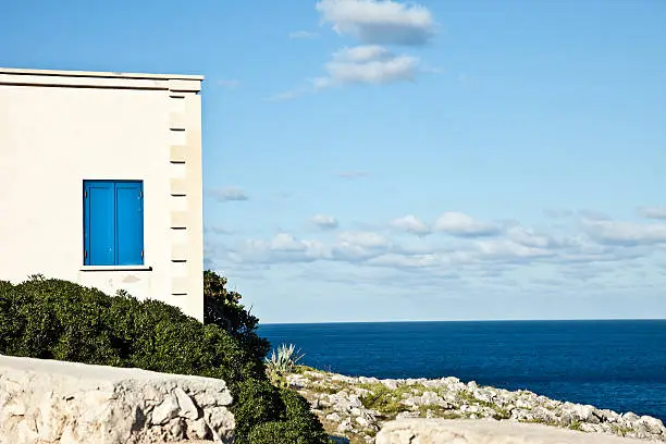 Typical italian house from Salento (Apulia) overhanging the sea.