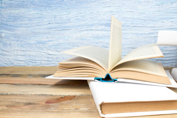 istock open book, books on the blue background. Back to school. Education. Copy space for text. 1832981586