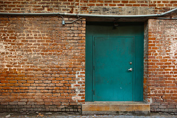 istock Brick wall and green door 183298449