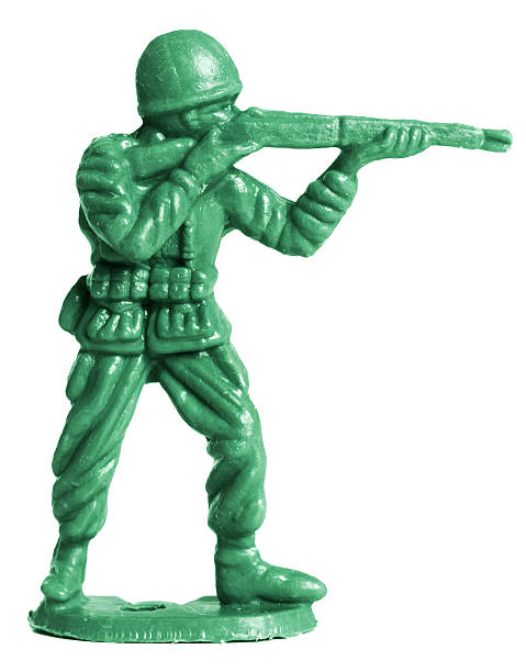 A green toy soldier taking aim with his gun Toy soldier macro.  toy soldier stock pictures, royalty-free photos & images