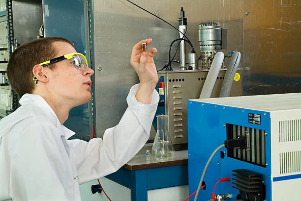 Student or scientist examining sample in a bottle stock photo