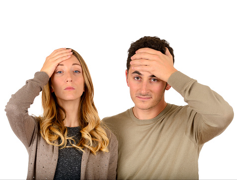 Young couple worried on white background