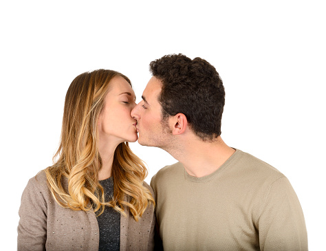 Young couple kissing on white background