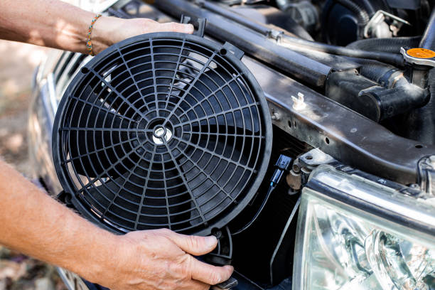 istock installing a car engine cooling fan. Auto repair and maintenance. 1833004895