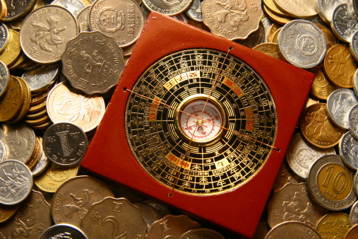 luopan compass among coins - wider angle