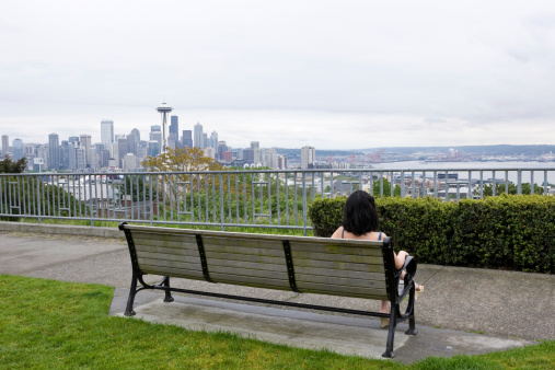 Woman Sitting On A Bench In A Seattle Park