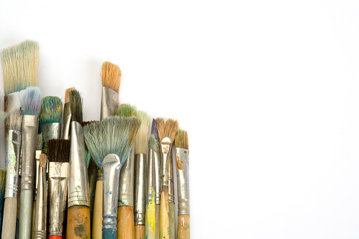 Three dirty paintbrushes be stained with color on isolated white background. Art colorful paintbrush and painting and drawing tool of artist.