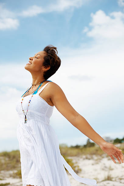 istock Mixed race woman enjoying the fresh air on beach 183301309