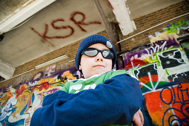 child rock star, try walking in my shoes... "five year young boy posing with sunglasses like a rock star, being 'the coolest guy in my kindergarden' :-).made in frog perspective, wide angle with Canon 1Ds MK II, Canon 24-105mm f4 L lens." rap kid stock pictures, royalty-free photos & images