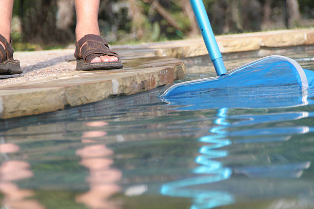 istock Close-up of pool guy doing pool maintenance 183301830